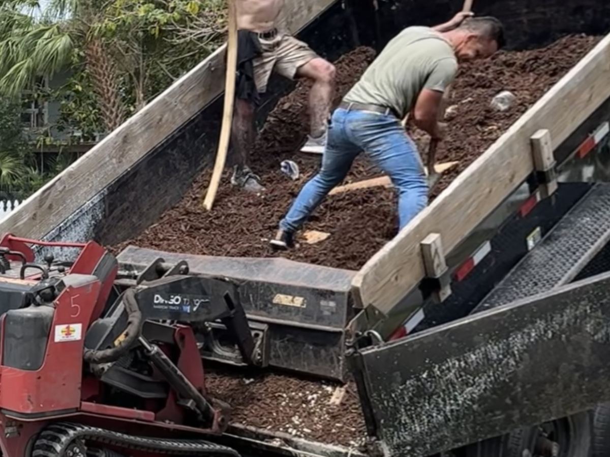 Volunteers moving soil during a home build